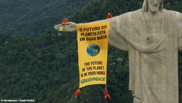Greenpeace-Aktivisten mit Banner auf der Christusstatue in Brasilien.