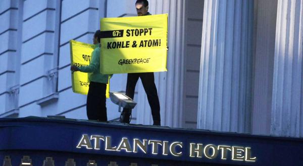 Vor dem Hamburger Hotels Atlantic protestieren Greenpeace-Aktivisten beim G7-Energieminister-Treffen für eine saubere Energiewende