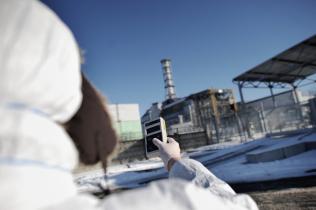 Greenpeace-Atomexperte Tobias Münchmeyer misst radioaktive Strahlung am Sarkophag des Atomkraftwerks in Tschornobyl.