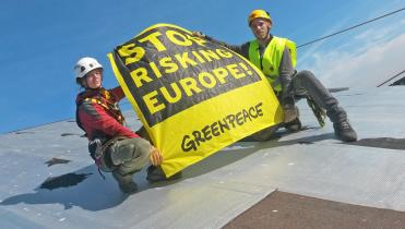 Auf dem Dach des Atommeilers Fessenheim halten Greenpeace-Aktivisten ein Banner mit der Aufschrift "Stop Risking Europe"