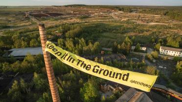 Zwischen zwei Fabrikschornsteinen in Haidemühl, Lausitz, haben Greenpeace-Aktivisten ein Banner gespannt mit der Aufschrift "Keep it in the Ground".