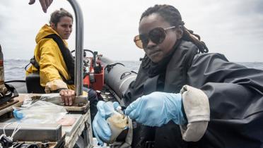 Deckhand Celine und Greenpeace-Aktivistin Bukelwa bereiten Wasserproben auf einem der Festrumpfschlauchboot vor.