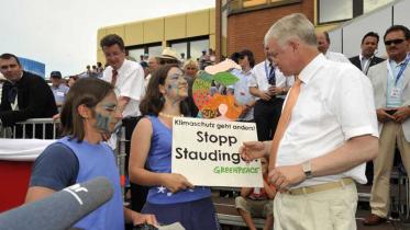 Greenpeace-Gruppe Marburg überreicht auf dem Hessentag ein Schild "Klimaschutz geht anders" an Ministerpräsident Roland Koch, Juni 2009