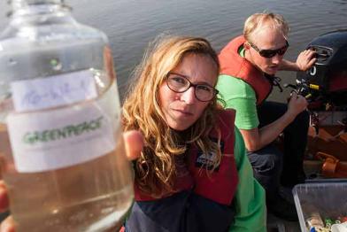 Greenpeace-Aktivisten nehmen von einem Schlauchboot aus Wasserproben aus der Schlei in Schleswig Holtein.