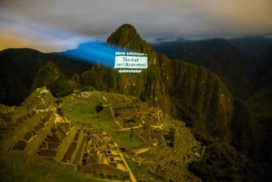 Eine Projektion "Klima schützen - Solar ausbauen!" wird von Greenpeace-Aktivisten auf den Berggipfel des Machu Piccu geworfen