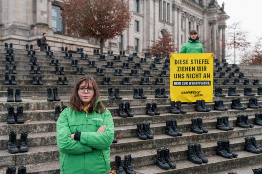 Greenpeace Youth Protests against Conscription with "Bundeswehr" Boots in Berlin