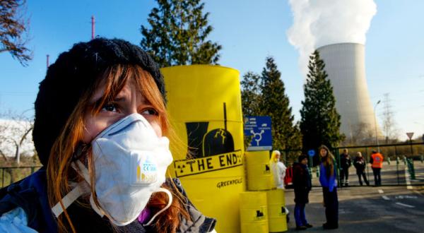 Greenpeace-Aktivisten protestieren mit Atomfässern mit der Aufschrift "The End" vorm belgischen AKW Tihange.