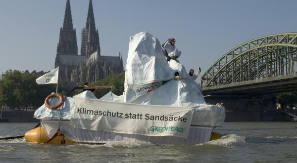 Eisberg Tour auf dem Rhein: Als Pinguine verkleidete Aktivisten stehen auf dem Eisberg, Oktober 2006