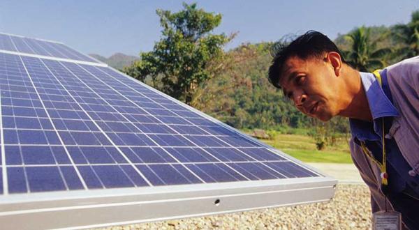 Solarprojekt in Thailand: Techniker Prajak Vong Pan an Solaranlage, Dezember 2004
