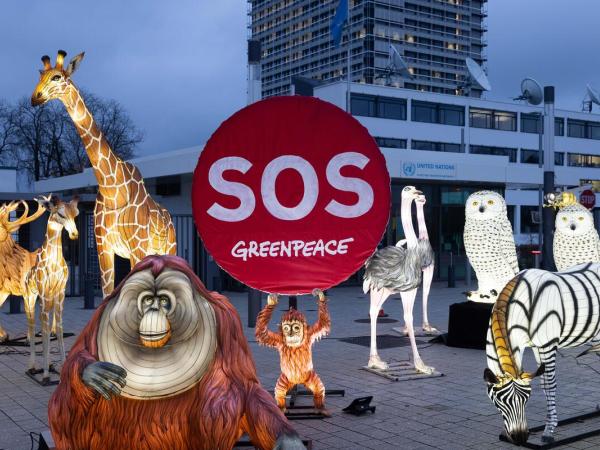 Protest with Luminous Animal Figures for Protecting Nature in front of UN Building in Bonn